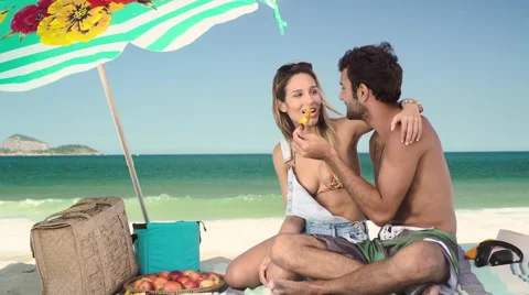 Romantic couple relaxing and having skewered fruits on beach Stock-Footage 59375813