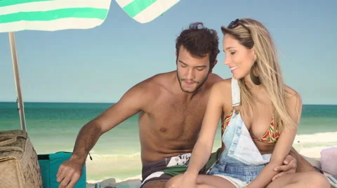 Romantic couple relaxing and having skewered fruits on beach Stock Footage 59376036