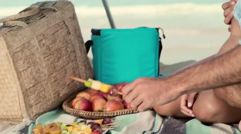 Romantic couple relaxing and having skewered fruits on beach Stock Footage 59376130
