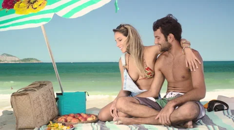 Romantic couple relaxing and having skewered fruits on beach Stock Footage 59441692