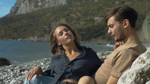 Romantic couple relaxing on the beach Stock Footage 72156345