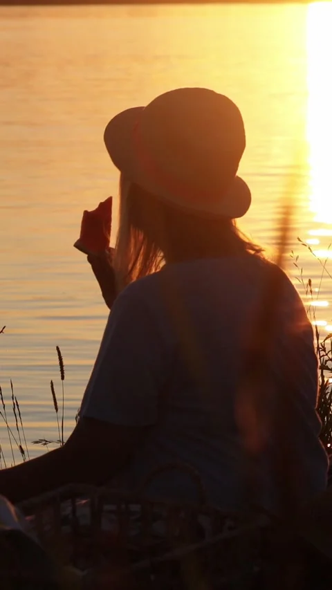 Romantic Couple Sharing Watermelon at Sunset by Lake, Summer Love Scene Stock Footage 332307536