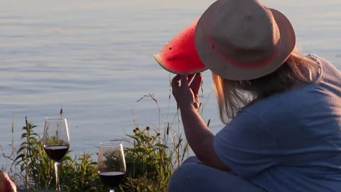 Romantic Couple Sharing Watermelon at Sunset by Lake, Summer Love Scene Stock Footage 332307570