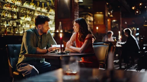 Romantic couple sitting bar talking smiling together. Loving pair discussing Vídeo Stock 334003606