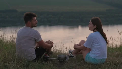The romantic couple sitting on mountain top and drinking tea. slow motion Stock Footage 159596063