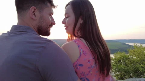 The romantic couple sitting on the mountain top against the beautiful river Stock Footage 159652559