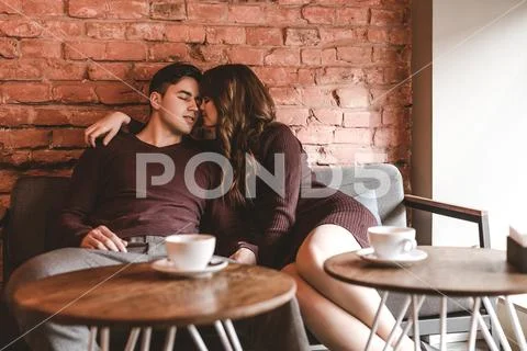 The romantic couple sitting in the restaurant Stock Photos