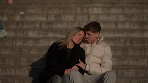 Romantic couple sitting on steps in Paris France enjoying each other's company Stock Footage 325262763