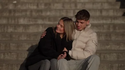 Romantic couple sitting on steps in Paris France Young woman and man embracing Stock Footage 328566938