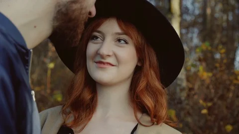 Romantic couple smiling and easy kissing each other in a park Video stock 104472940