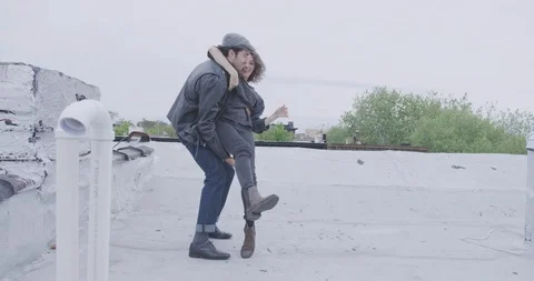 Romantic Couple Spin Together On Rooftop Stock Footage 94446545