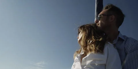 Romantic couple standing on deck of sailboat Stock Footage 58861309
