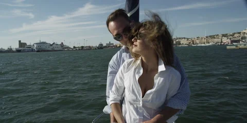 Romantic couple standing on deck of sailboat Stock Footage 58861326