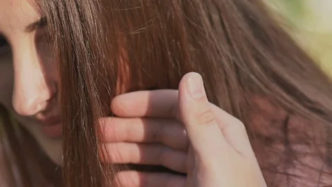 Romantic couple in summer on a glade. The hand of the enamored guy touches his Stock Footage
