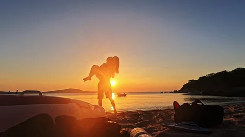 Romantic Couple at Sunset Beach, Man Carrying Woman Toward sea Video stock 335699281
