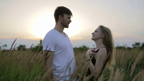 Romantic Couple at Sunset. Two people in love at sunset or sunrise. Man and woma Stock Footage