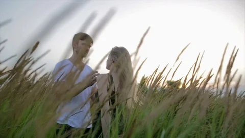 Romantic Couple at Sunset. Two people in love at sunset or sunrise. Man and woma Stock Footage