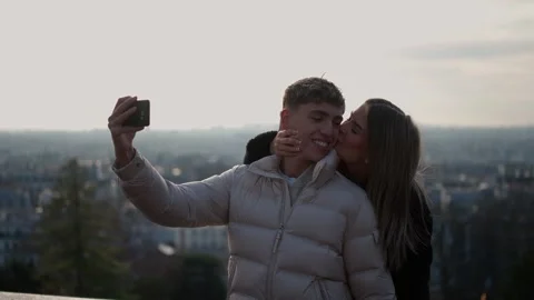 Romantic Couple Taking Selfie with Paris Cityscape in Background Young woman Stock Footage 325257157