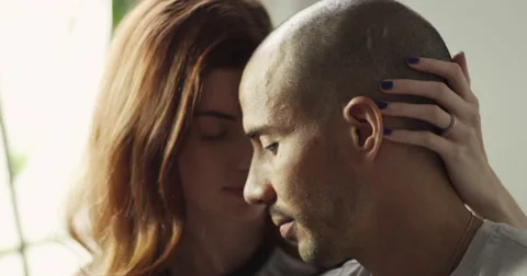 Romantic couple talking to each other in living room Vídeo Stock 63374103