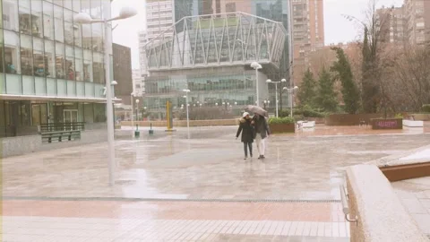 Romantic Couple Walking and Running in Rain with Umbrella 動画素材 297415875