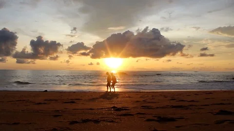 Romantic Couple Walking At The Beach at sunset Stock Footage 95878636