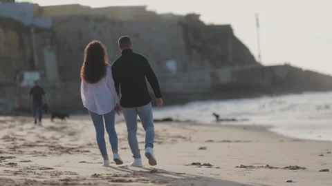 Romantic couple walking on beach at sunset Stock Footage 306247593