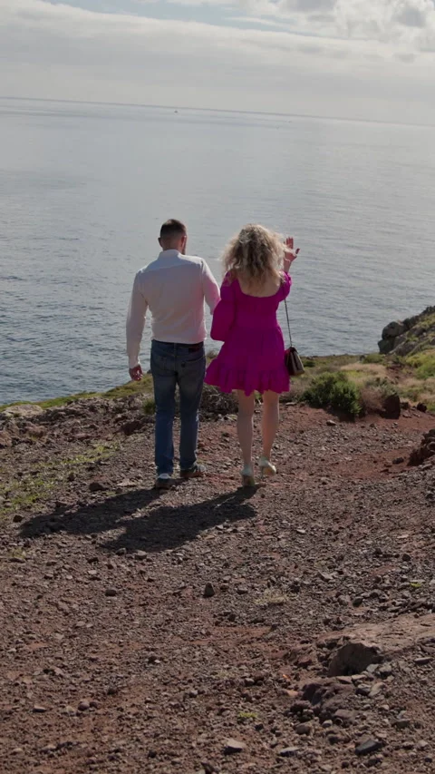 Romantic couple walking on cliff overlooking ocean in madeira Stock Footage 327041941