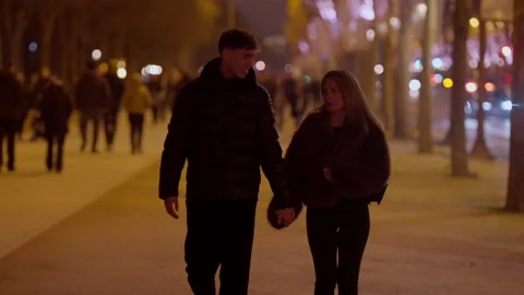 Romantic Couple Walking Hand-in-Hand at Night in Paris France Trees and City Stock Footage 325276053