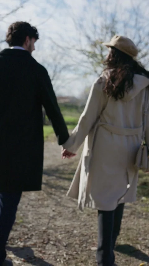 Romantic couple walking hand in hand on a path Stock Footage 325700768