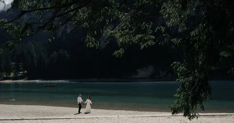 Romantic couple walking in the middle of the forest ,holding the hands, in the Video stock 83411876