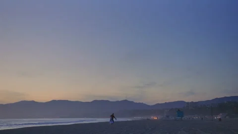 Romantic couple walking on sandy beach at sunset Stock Footage 178409622