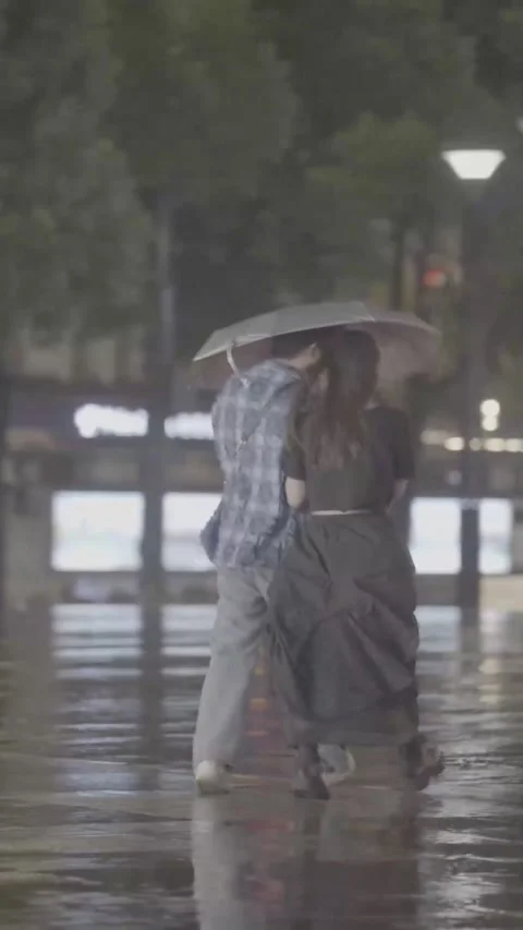 Romantic Couple Walking Under Umbrella in Rainy Night City Stock Footage 326599984