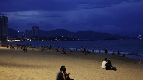 Romantic couples sitting on sandy beach at night Video stock 336099839