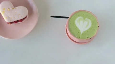 Romantic date in cafe with matcha latte and lovely heart dessert on Valentine's Stock Footage 168672308