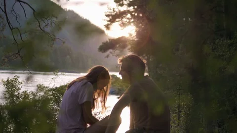 Romantic date of lovers at sunset by a mountain stream. Stock Footage 111874105