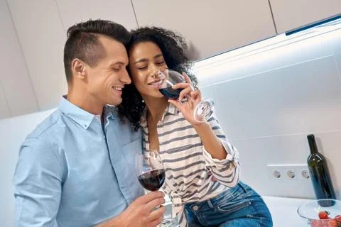 Romantic Date. Young multiethnic couple standing at kitchen cooking dinner Stock Photos