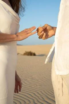 Romantic desert proposal at sunset Stock Photos