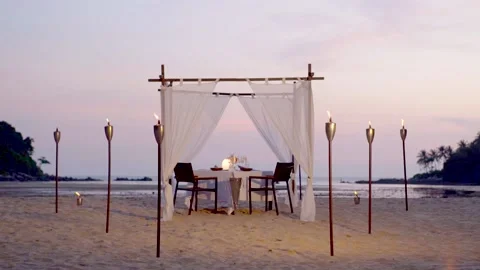 Romantic dining set up beach ocean sunset Stock Footage 144588007