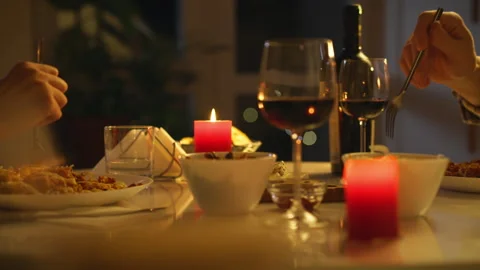 Romantic dinner with candlelight and wine at a cozy table setting Stock Footage 295892323