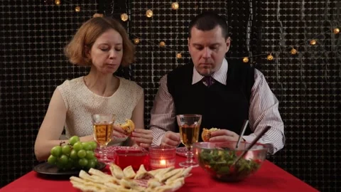 Romantic Dinner Celebration: Couple Sharing Food at Decorated Table Stock Footage 306529699