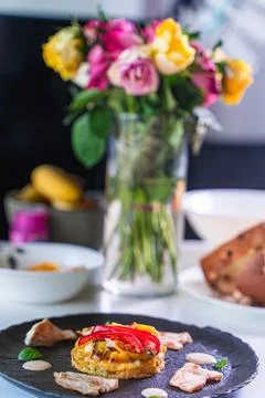 Romantic dinner. Cooked chicken or turkey pieces with potato tartilla and red Stock Photos