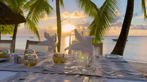 Romantic dinner at sea beach in water against wonderful sunset at summer sandy Stock Footage 170219227