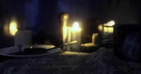 Romantic dinner setting with candles and soft lighting in cozy room Illustrazione stock