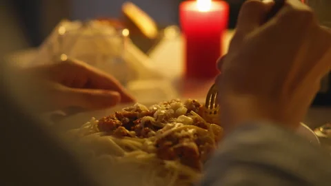 Romantic dinner setting with spaghetti and candlelight in the evening Stock Footage 295160643