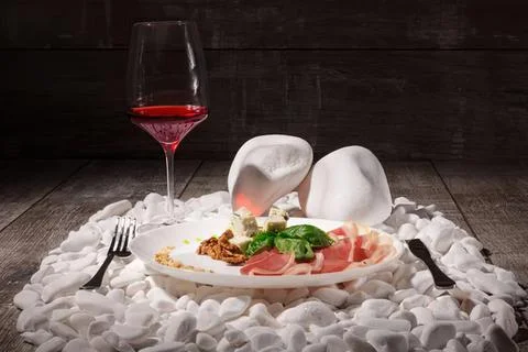 Romantic dinner setting with wine, cheese, and fruits Stock Photos