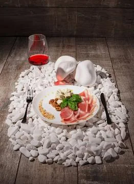 Romantic dinner setting with wine, flowers, and candles Stock Photos