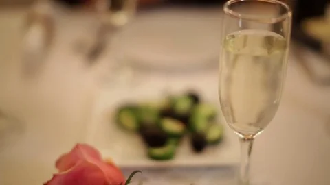 Romantic Dinner Table Setting Background with Rose and Champagne Stock Footage 71702369