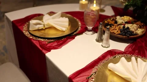Romantic dinner table setting with gold plates Stock Footage 337495441