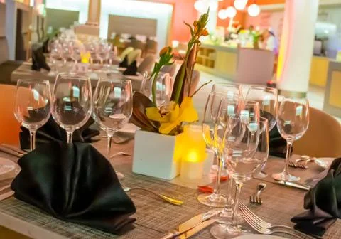 Romantic dinner table setup decoration with candle light in a restaurant. Sel Stock Photos