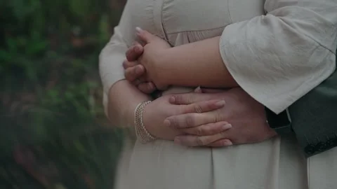 Romantic embrace with intertwined hands Video stock 303949384